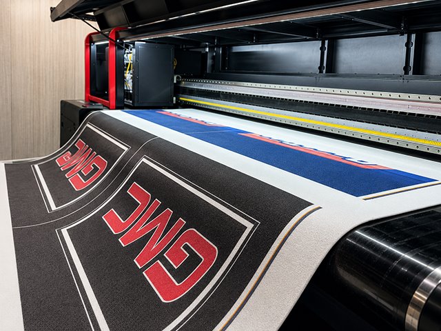Industrial digital printing machine producing custom logo mats